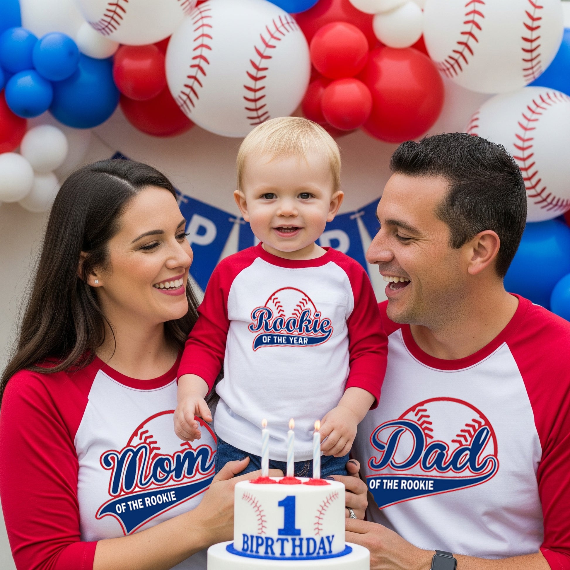 Family of three celebrating a child's first birthday with baseball-themed shirts Rookie of the year and decorations.